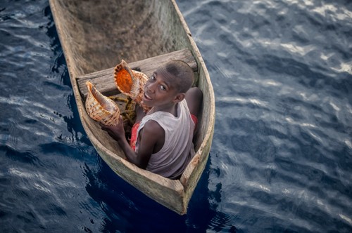 Solomon Boy in Canoe Selling Triton Shell
